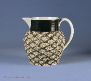 Creamware 'pineapple' jug with Grogged or gravel type shredded clay decoration (related to mochaware), under-glaze oxide decoration. 115mm High. c.1790-1820. AP/184.