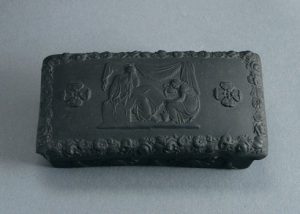 Black basalt pill box or match striker, with lid. Wedgwood, C19th pre-1891. 94mm Long. AP/564.