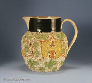 Creamware jug with Grogged or gravel type shredded clay decoration. Only recorded example with pictorial under-glaze oxide decoration. 188mm High. c.1800-1820. AP/812.