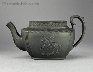 Dry-bodied black basalt teapot with Duke of Wellington sprigs. 119mm High. c.1815-1820. AP/909.