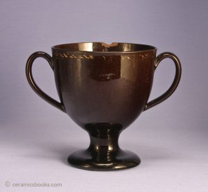 Jackfield (Shining Black) loving cup with traces of gold gilding. 136mm high. c.1800-1820. AP/097.