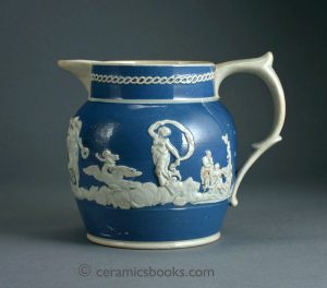 Pearlware jug with blue slip gound. Britannia, Fame & Venus sprigs etc.. 118mm High. c.1815-1830. AP/433.
