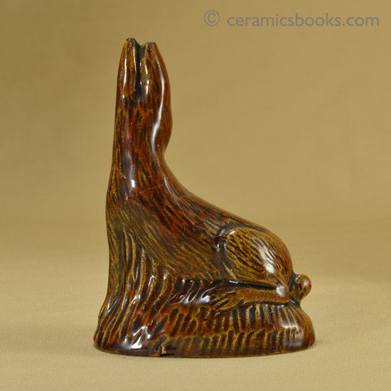 Small treacleware figure of a hare or rabbit.. Reverse. AP/1028.