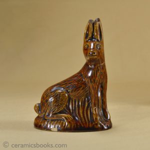 Small treacleware figure of a hare or rabbit.. Obverse. AP/1028.