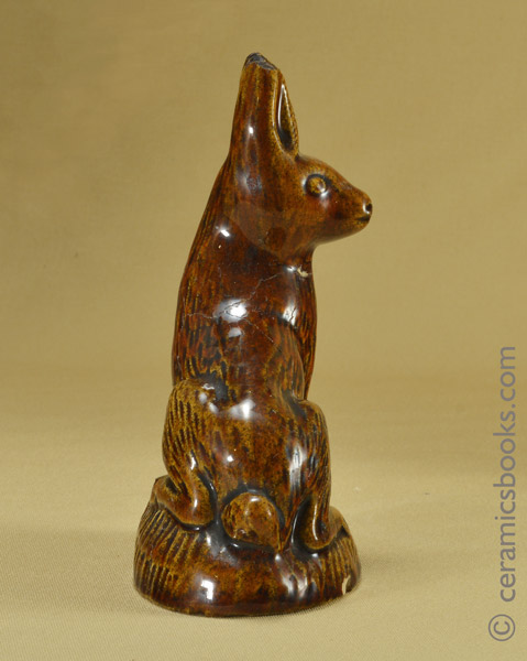 Small treacleware figure of a hare or rabbit.. Side. AP/1028.