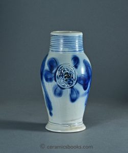 Scratch blue salt-glazed stoneware jug with King George III “GR” portrait medallion. 158mm High. c.1760-1790. AP/1047.