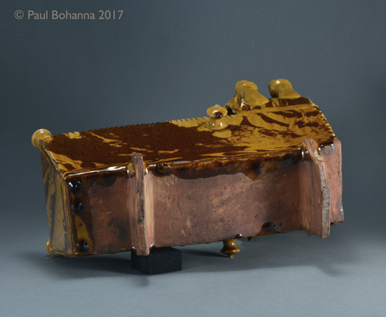 Agateware cradle with slip inscription “M J + R 1856”. Attributed to Woodman House Pottery, Halifax. Base. P/1072.