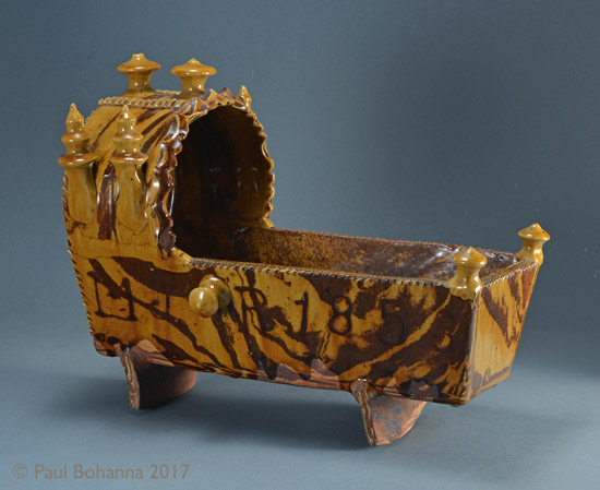 Agateware cradle with slip inscription “M J + R 1856”. Attributed to Woodman House Pottery, Halifax. Reverse. P/1072.