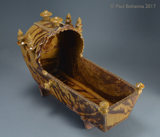 Agateware cradle with slip inscription “M J + R 1856”. Attributed to Woodman House Pottery, Halifax. Above. P/1072.