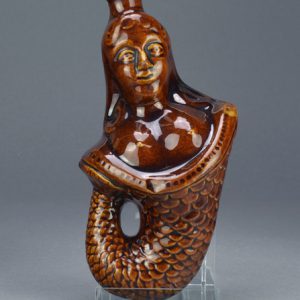 Treacleware (Rockingham glazed) figural spirit flask in the form of a mermaid c.1840-1870. Front. AP/1121.