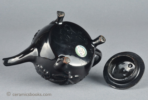 Shining Black 'Jackfield' type teapot on 3 feet with applied vine leaf and flower sprigs c.1755-1765. Base. AP/1240.