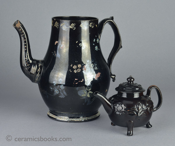 A very large Shining Black 'Jackfield' type coffeepot with cold enamelled flowers c.1770-1780. Obverse. AP/1254 plus teapot AP/1240.