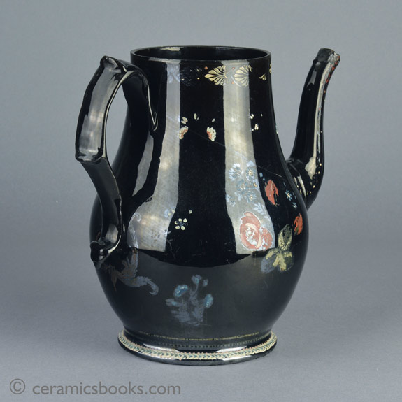 A very large Shining Black 'Jackfield' type coffeepot with cold enamelled flowers c.1770-1780. Back. AP/1254.