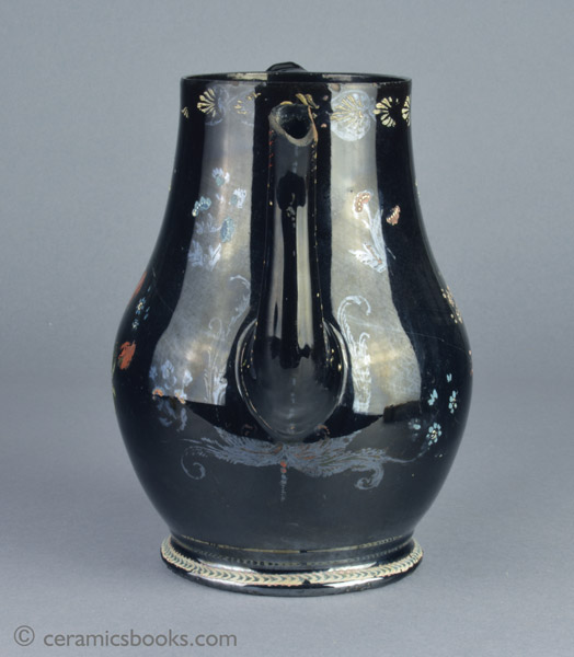 A very large Shining Black 'Jackfield' type coffeepot with cold enamelled flowers c.1770-1780. Front. AP/1254.