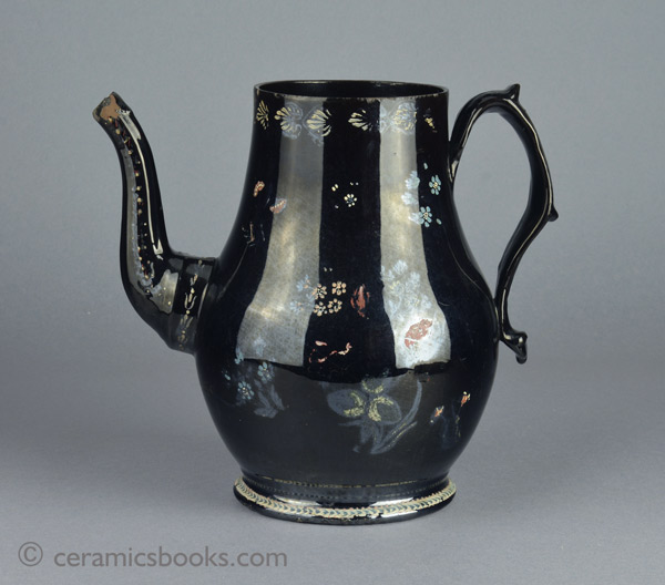 A very large Shining Black 'Jackfield' type coffeepot with cold enamelled flowers c.1770-1780. Obverse. AP/1254.