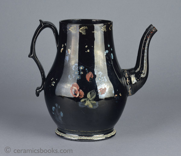 A very large Shining Black 'Jackfield' type coffeepot with cold enamelled flowers c.1770-1780. Reverse. AP/1254.