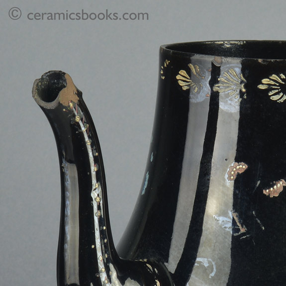 A very large Shining Black 'Jackfield' type coffeepot with cold enamelled flowers c.1770-1780. Spout lip. AP/1254.