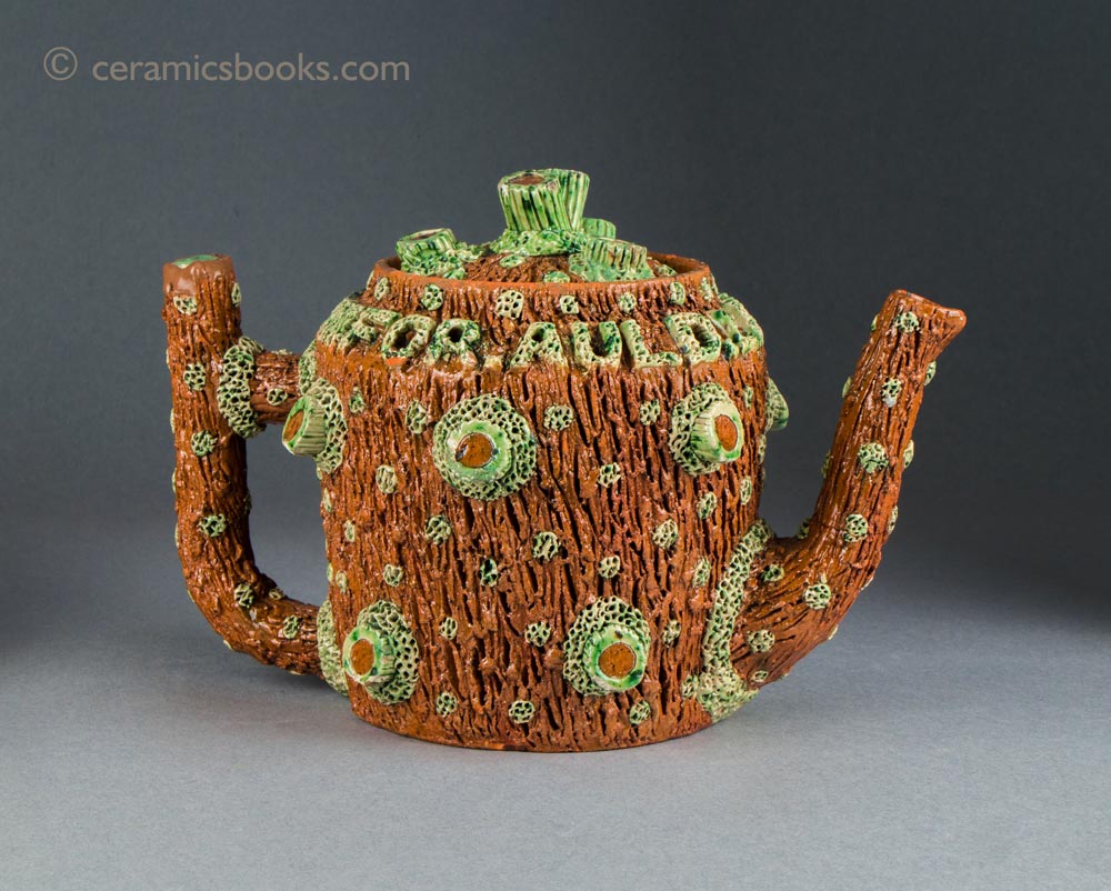Rustic earthenware crabstock teapot with white clay and green glaze highlights. "FOR.AULD.LANG.SYNE". Assumed to be Sussex, possibly Rye. 152mm High. c.1860-1890(?). AP/1494.