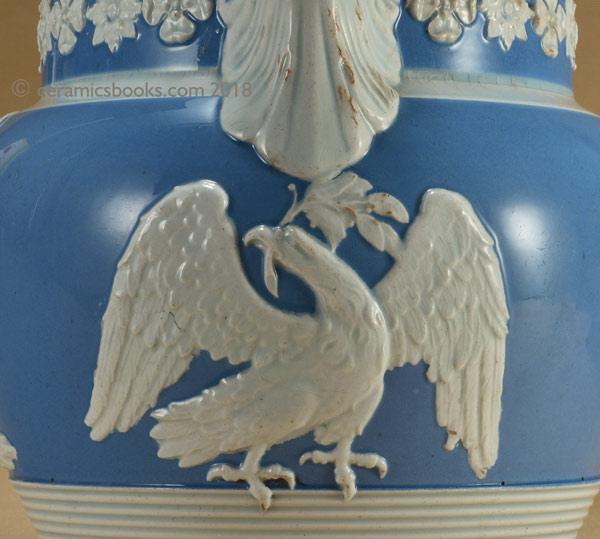Pearlware blue ground jug with white clay sprigs including a greyhound, an eagle and a stag. Eagle sprig. AP/722.