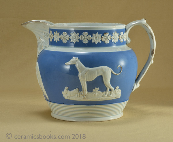 Pearlware blue ground jug with sprigs of a greyhound, an eagle and a stag. 145mm high. c.1820-1840. AP/722.