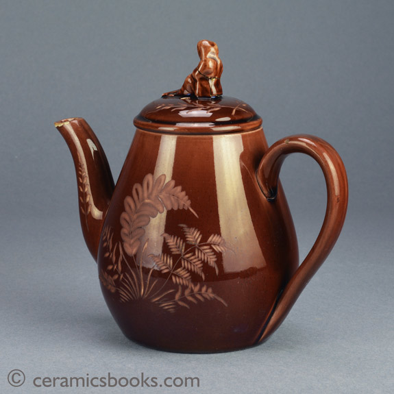Small ‘Vigornian’ ware (treacleware) teapot with Sybil finial, attributed to Wedgwood. c.1878-1890. Back. AP/752.