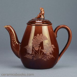 Small ‘Vigornian’ ware (treacleware) teapot with Sybil finial, attributed to Wedgwood. c.1878-1890. Obverse. AP/752.