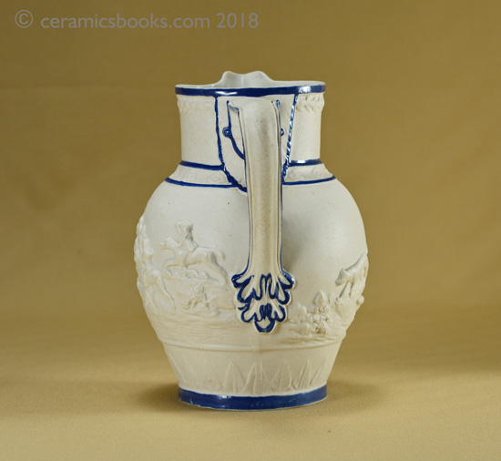 Felspathic stoneware slip-cast jug with hunting scene, blue enamel edging. Back. AP/782.