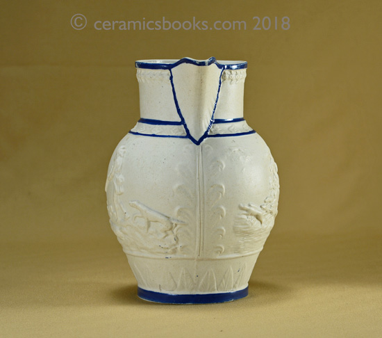Felspathic stoneware slip-cast jug with hunting scene, blue enamel edging. Front. AP/782.