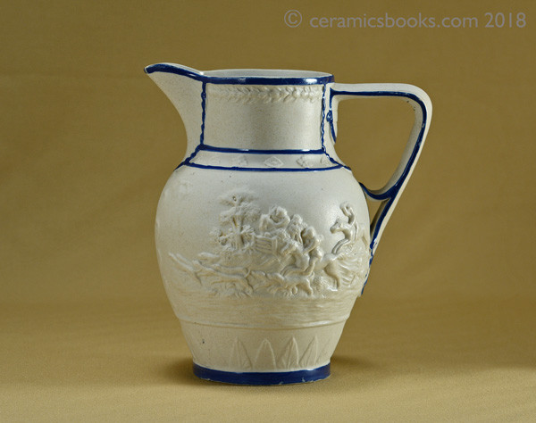 Felspathic stoneware slip-cast jug with hunting scene, blue enamel edging. Obverse 2. AP/782.