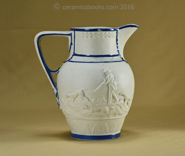 Felspathic stoneware slip-cast jug with hunting scene, blue enamel edging. Reverse. AP/782.