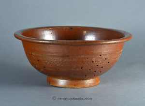 Brown salt-glazed stoneware colander with rouletted decoration. Probably Brampton. 268mm Wide. c.1840-1880. AP/811.