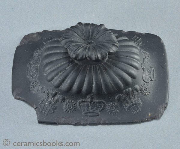 Black basalt teapot with crowns and Prince of Wales feathers possibly for coronation of King George IV. Top of lid. AP/859