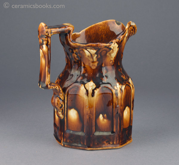 Two-tone treacleware moulded jug with Gothic arches. Back. AP/888.