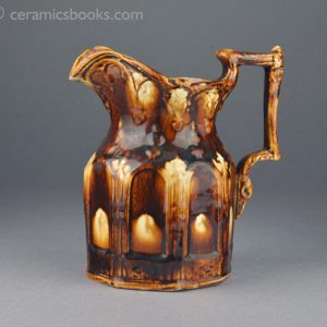 Two-tone treacleware moulded jug with Gothic arches. Obverse. AP/888.