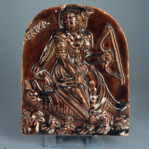 Treacleware (‘Rockingham’ brown glazed) wall plaque with icon of AMERICA. c.1800-1835. Front. AP/928.