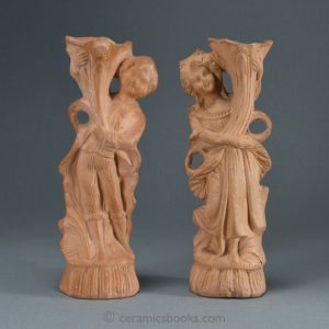 A pair of Continental terra-cotta figures, a boy and a girl with cornucopias. Front. AP/945 + AP/946.