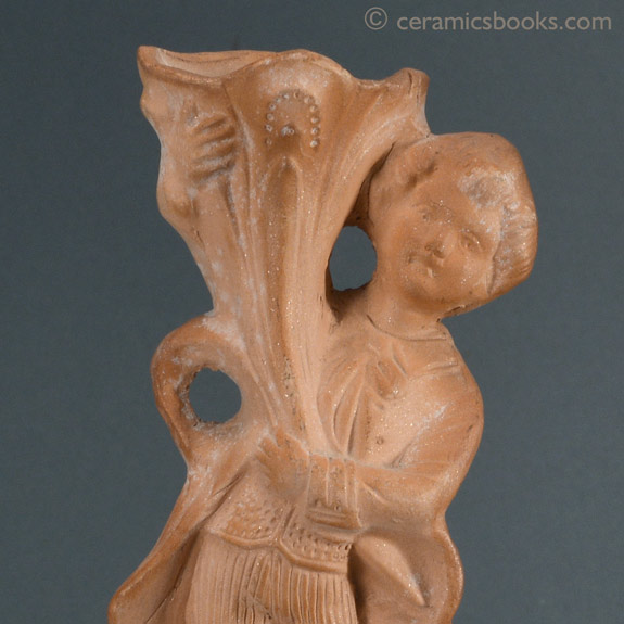 A pair of Continental terra-cotta figures, a boy and a girl with cornucopias. Boy face. AP/945 + AP/946.