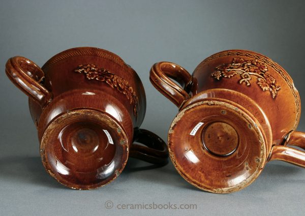 Two treacleware ('Rockingham' type glaze) chocolate cups or possibly loving cups. Bases. c.1840-1860. AP/393, AP/394.