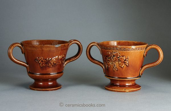 Two treacleware ('Rockingham' type glaze) chocolate cups or possibly loving cups. Reverse. c.1840-1860. AP/393, AP/394.