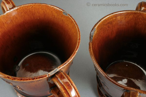 Two treacleware ('Rockingham' type glaze) chocolate cups or possibly loving cups. Rims. c.1840-1860. AP/393, AP/394.