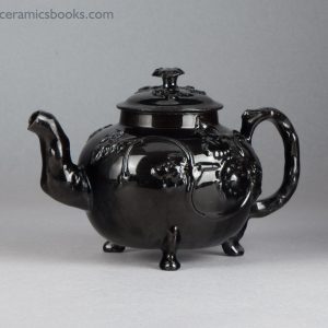 Jackfield type black-glazed teapot with grapevine and flower sprigs. Obverse, angle.