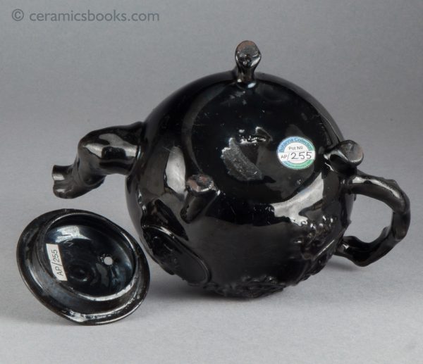 Jackfield type black-glazed teapot with grapevine and flower sprigs. Base.