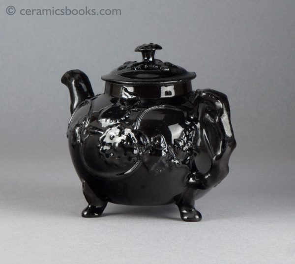 Jackfield type black-glazed teapot with grapevine and flower sprigs. Obverse back.