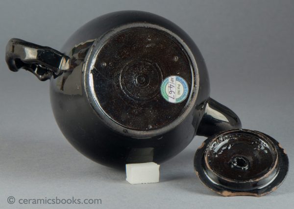 'Jackfield' type black-glazed globular teapot with crabstock handle and spout. c.1765-1780. Base.