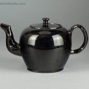 'Jackfield' type black-glazed globular teapot with crabstock handle and spout. c.1765-1780. Obverse.