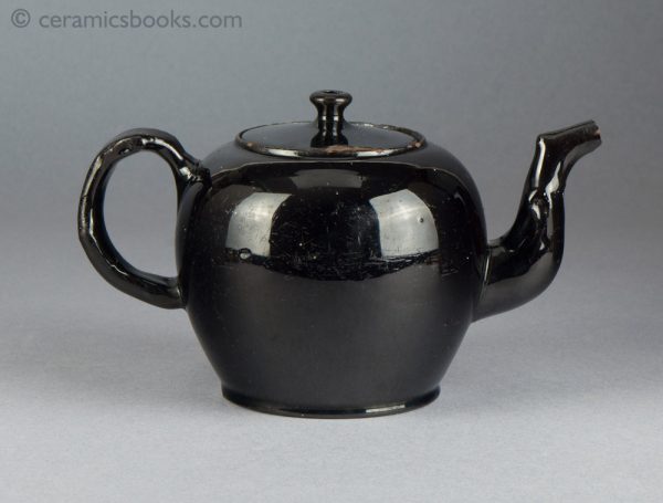 'Jackfield' type black-glazed globular teapot with crabstock handle and spout. c.1765-1780. Reverse.