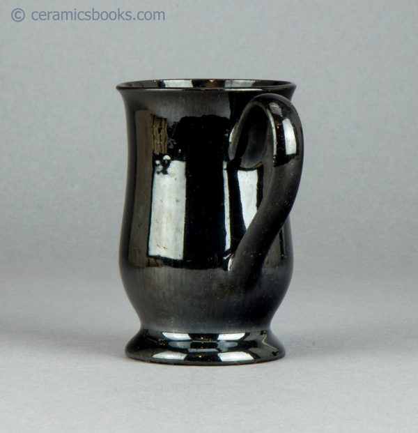 Small "Jackfield" type black glazed mug. c.1765-1785. AP/605. Back.