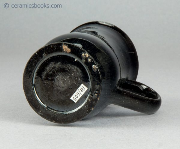 Small "Jackfield" type black glazed mug. c.1765-1785. AP/605. Base.