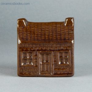 Lead-glazed redware moneybox (bank). Cottage with tiled roof. c.1860-1890. AP/744. Front.
