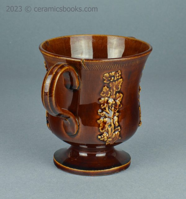 Treacleware loving cup with grapevine sprigs. c.1840-1870. AP/1009. Left side.